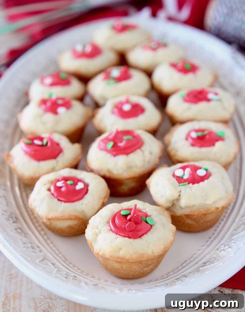 Sugar cookie cups filled with red frosting on white plate