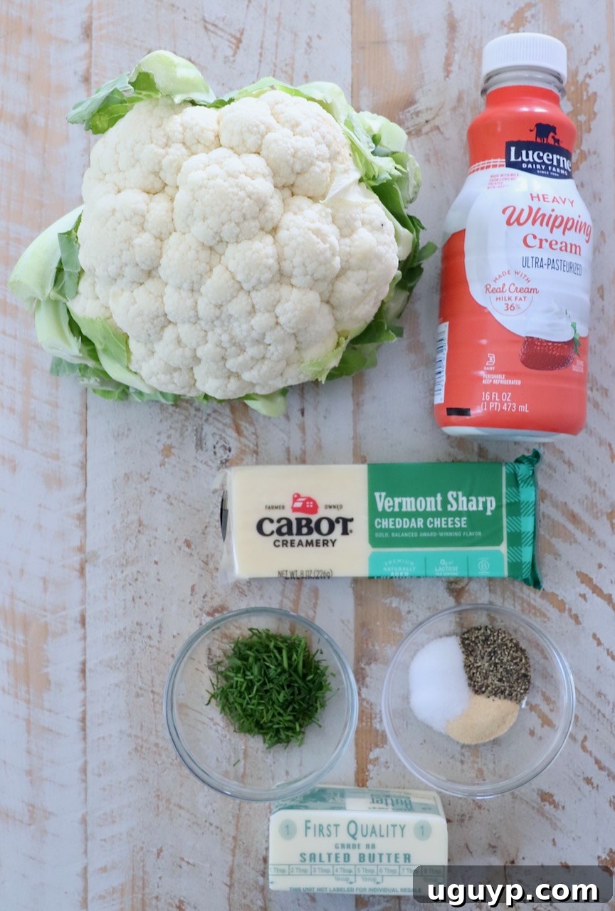 ingredients for mashed cauliflower on a white wood board