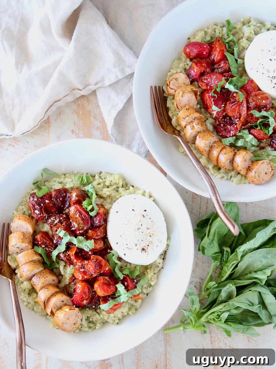 Close-up of a bowl of Instant Pot Pesto Risotto, artfully arranged with golden-brown Italian sausage slices, bright roasted cherry tomatoes, and a creamy sphere of burrata cheese.
