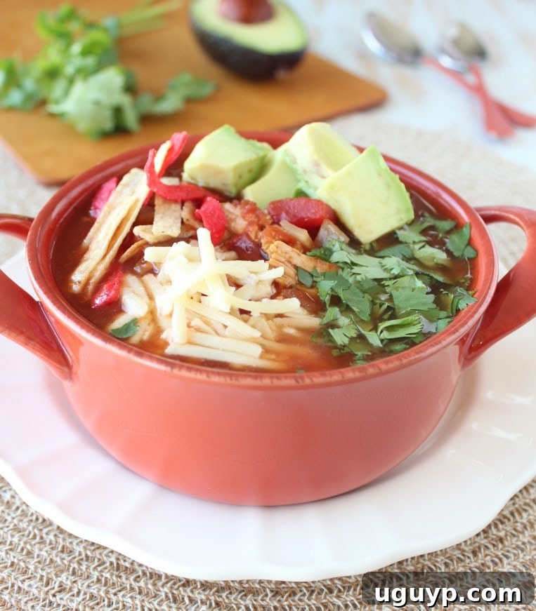 A rich Slow Cooker Chipotle Chicken Tortilla Soup Recipe, perfect for a comforting meal.