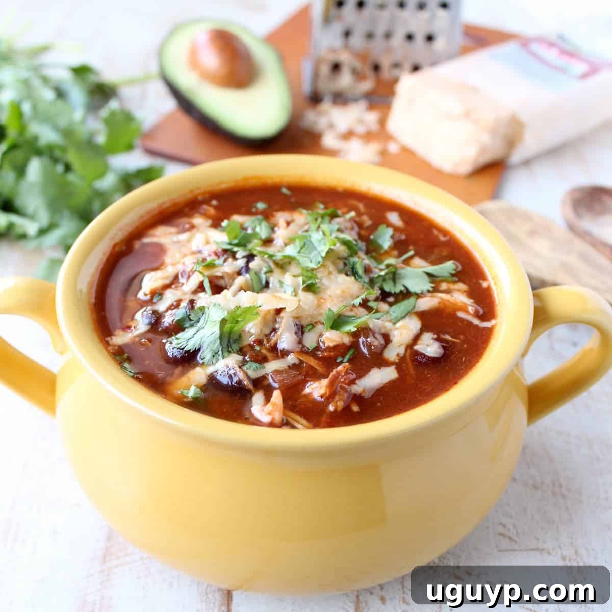 This Slow Cooker Chicken Enchilada Soup recipe offers a deliciously spicy kick from Sriracha, requiring only 10 minutes of easy preparation.