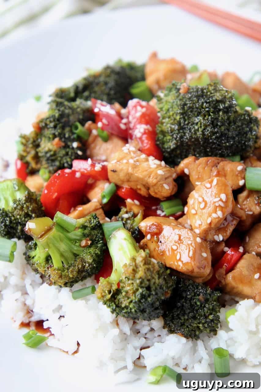 Teriyaki chicken pieces and broccoli over rice on plate
