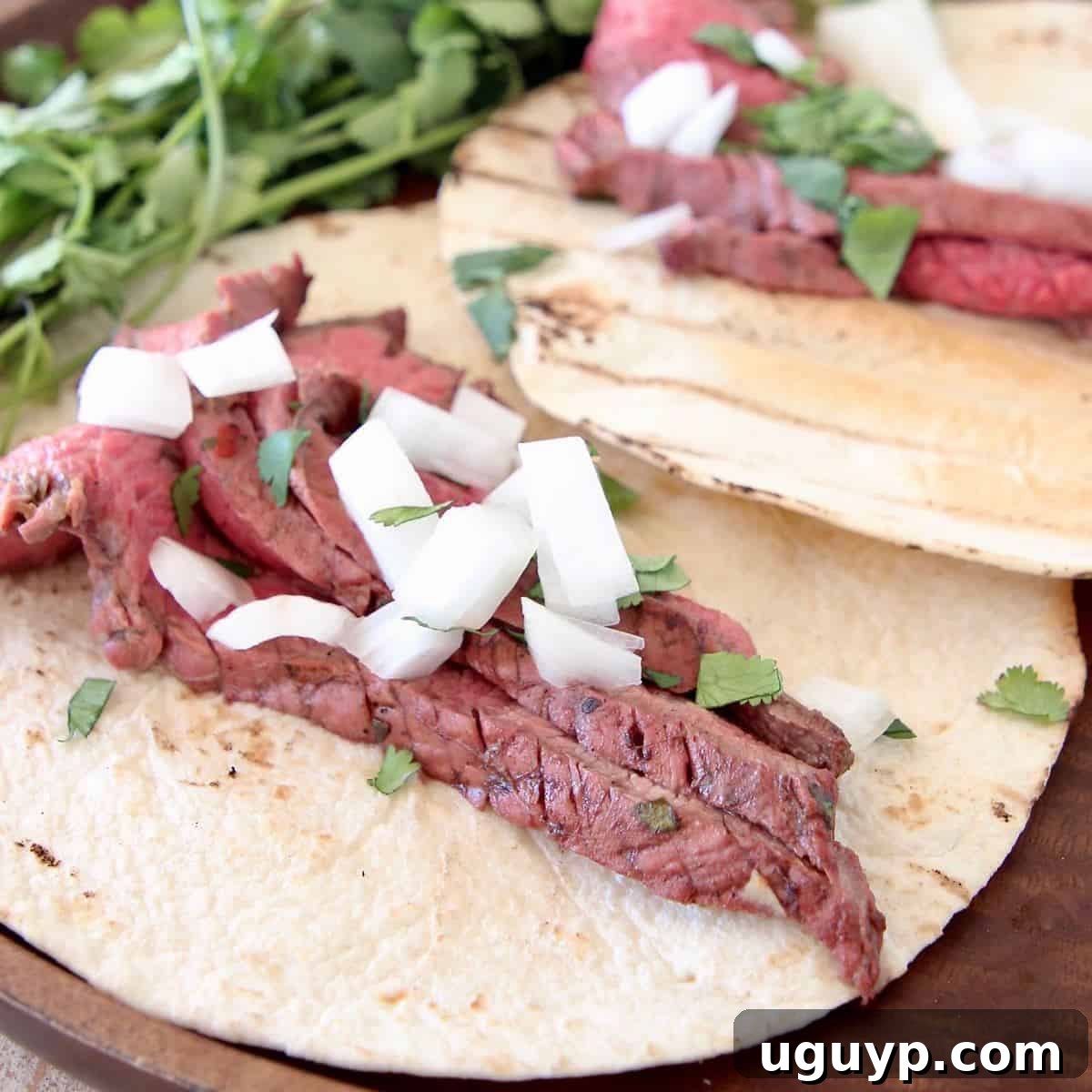Close-up of freshly sliced carne asada in tortillas