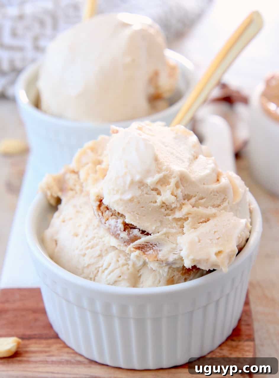 Scoops of peanut butter ice cream in bowls with gold spoons