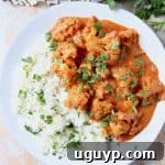Cauliflower on plate, covered with Indian butter curry sauce