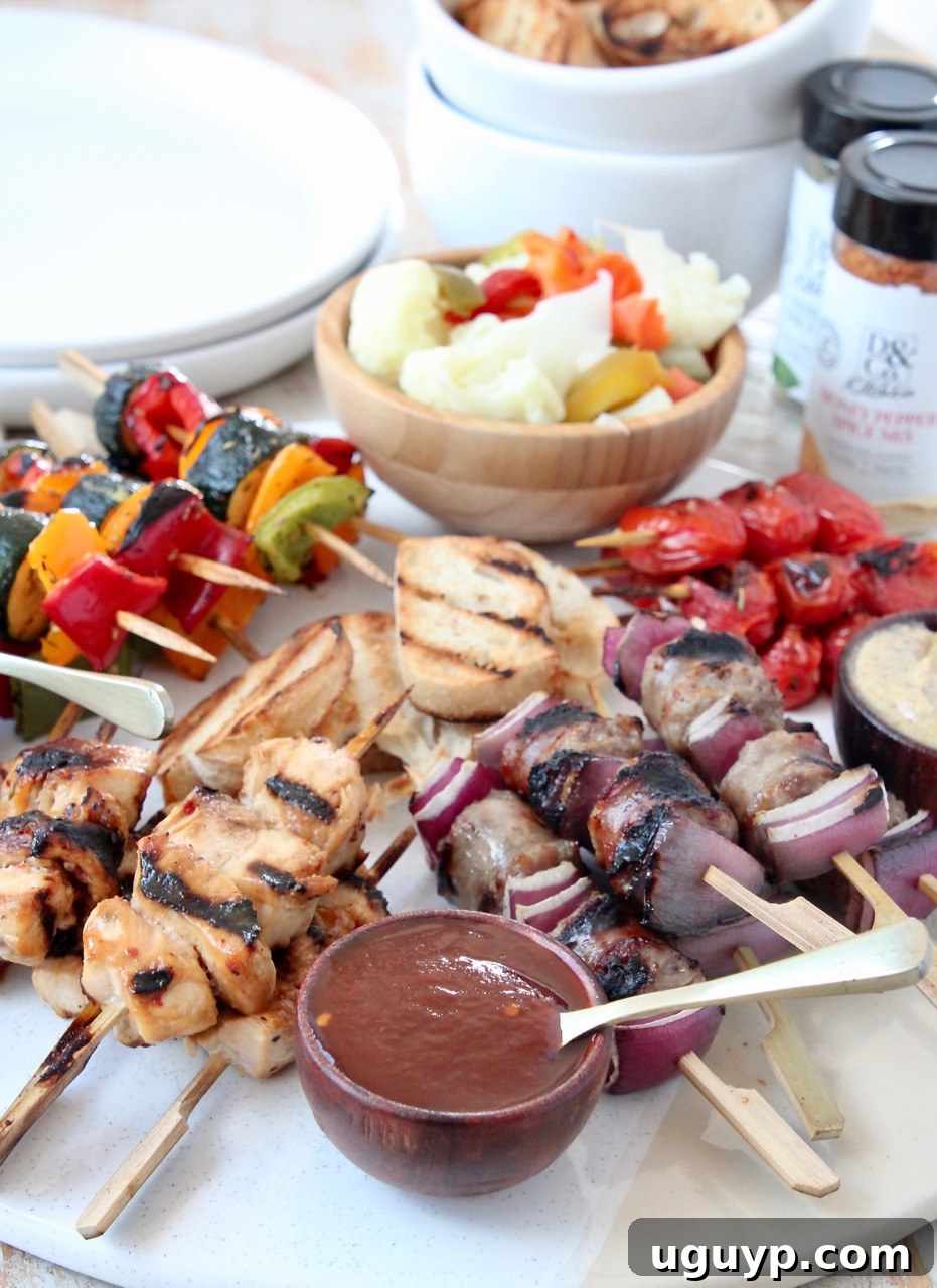 Grilled mini skewers on charcuterie board with bowls of sauces