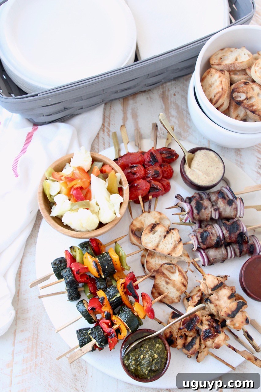 Grilled mini skewers on charcuterie board next to bowl of toasted baguette slices and basket of napkins