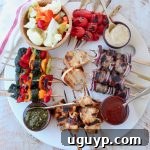 Overhead image of grilled skewers on charcuterie platter
