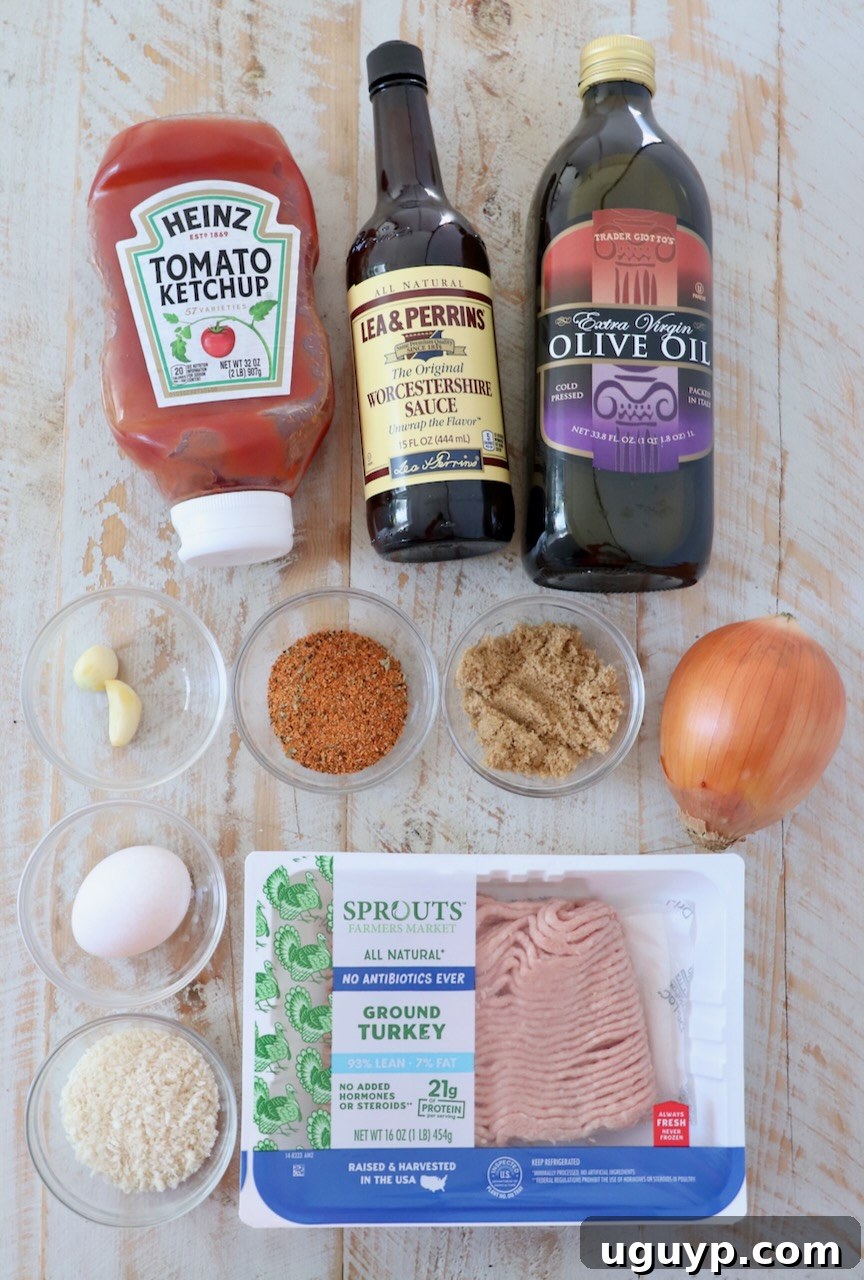 Ingredients for Mini Meatloaves laid out on a white wood board