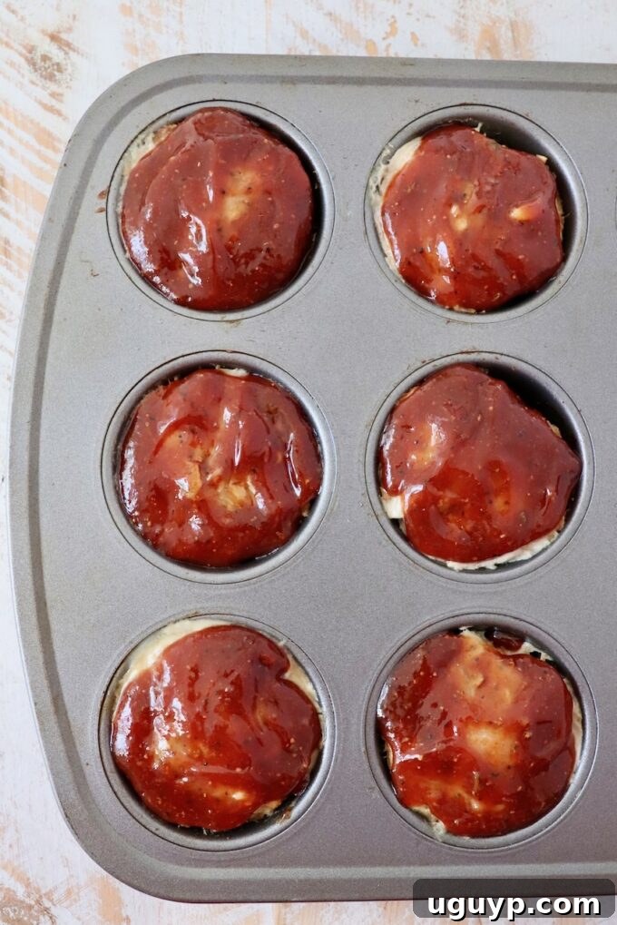 BBQ glazed mini meatloaves in a muffin tin