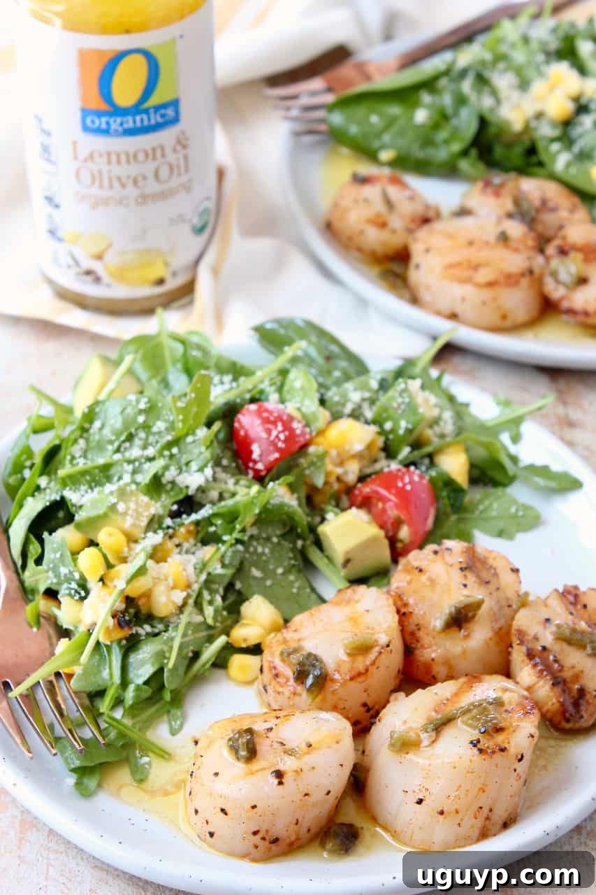 Close-up of perfectly grilled scallops served on a plate with fresh arugula salad and a fork ready to enjoy.