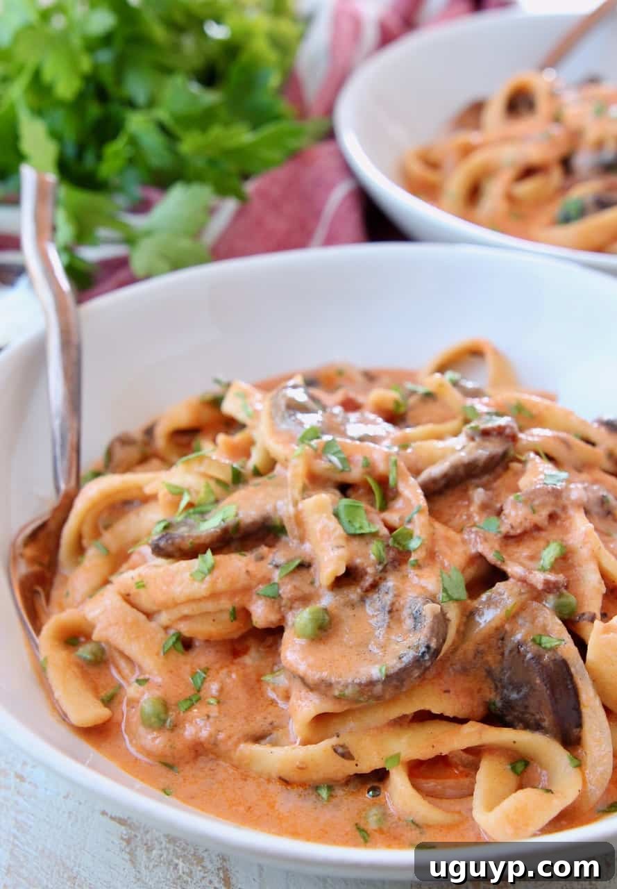Creamy bosciaola sauce with pasta in bowl with fork