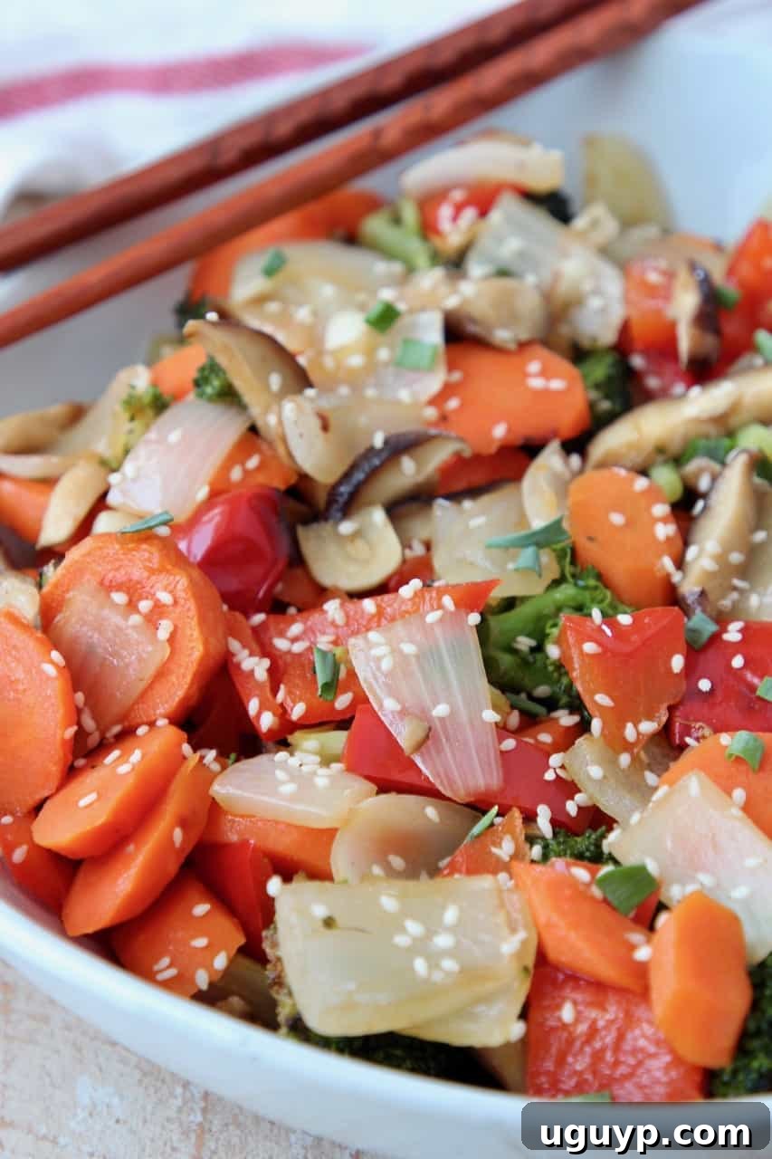 Roasted Asian vegetables in a bowl with chopsticks, ready to serve