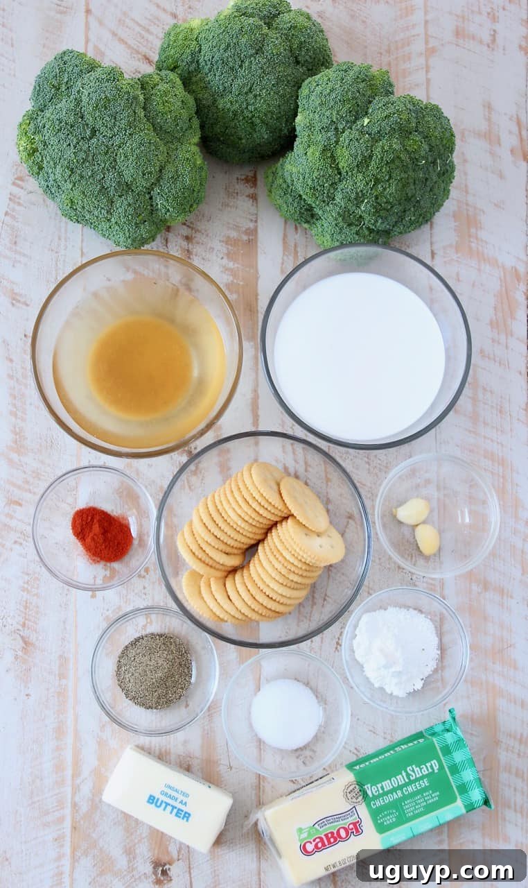 A vibrant display of fresh ingredients for broccoli cheese casserole, including broccoli, cheddar cheese, butter, and seasonings.