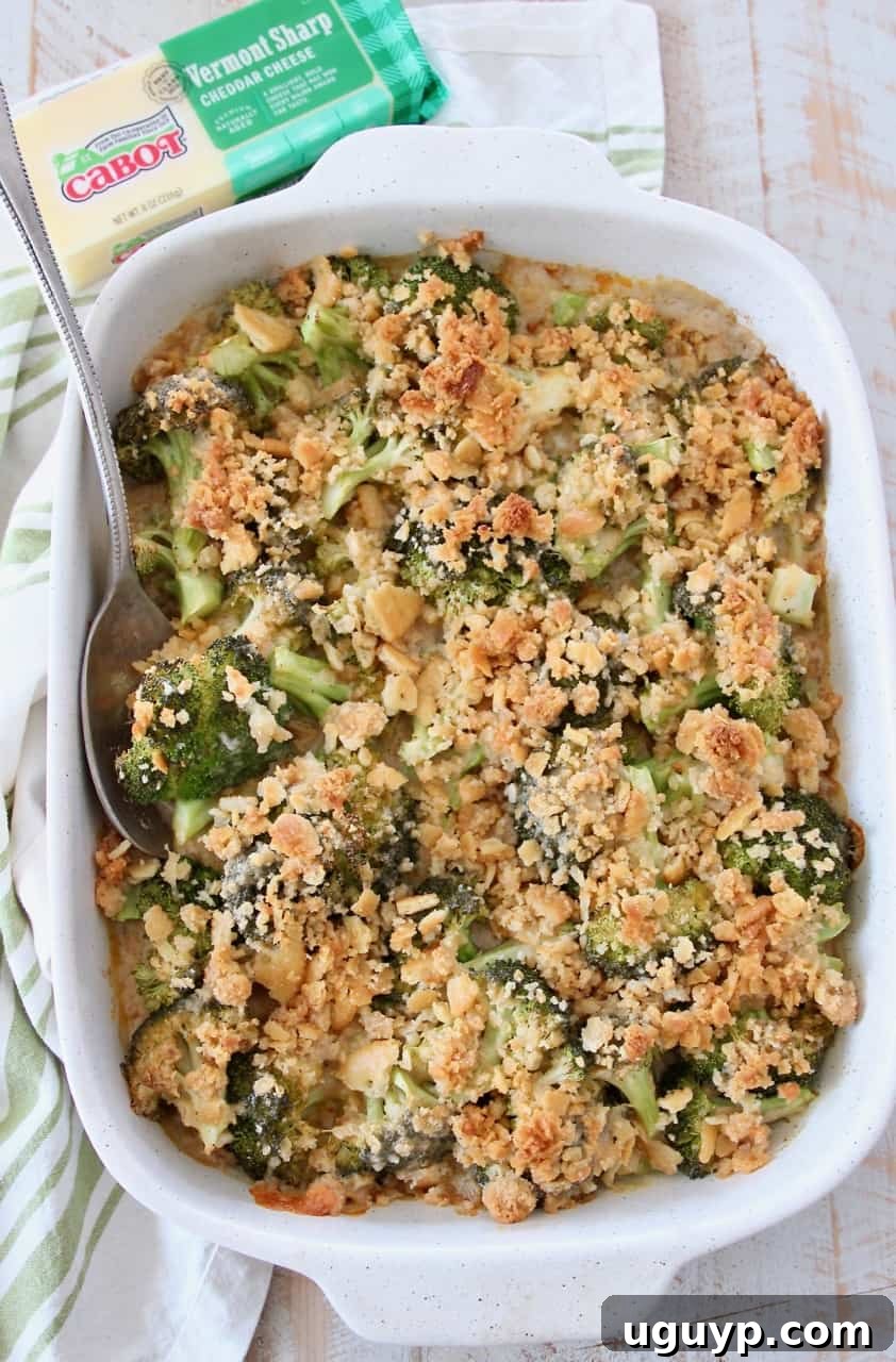 Overhead view of a finished broccoli cheese casserole with Ritz topping, ready to be served from the baking dish.