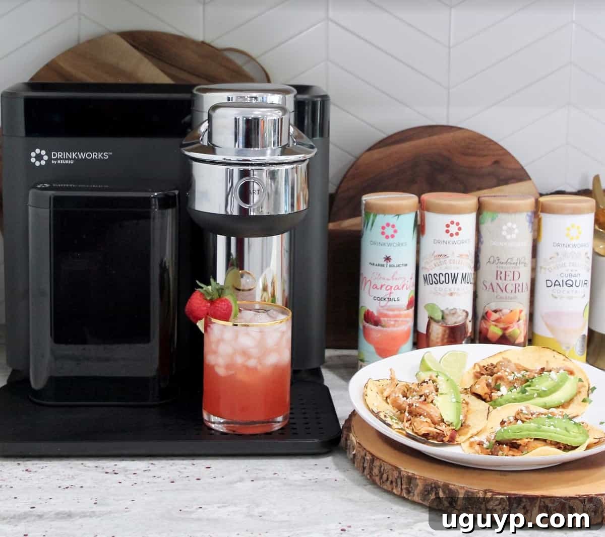 Chipotle Chicken Tacos on a plate next to a Drinkworks appliance with a strawberry margarita