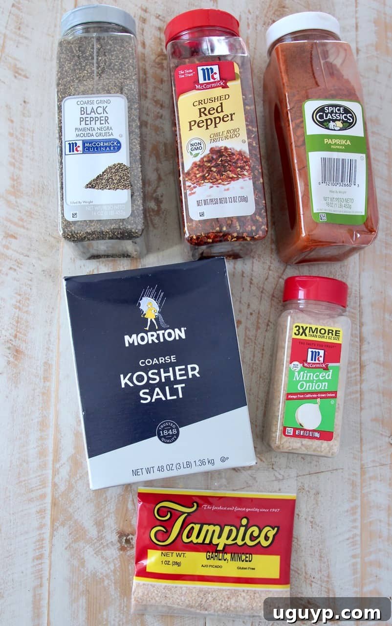 Overhead image of the six essential ingredients for Montreal steak seasoning laid out on a kitchen surface.
