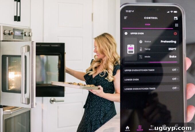 A woman opening a smart oven door, with a smartphone displaying the smart oven control app nearby.