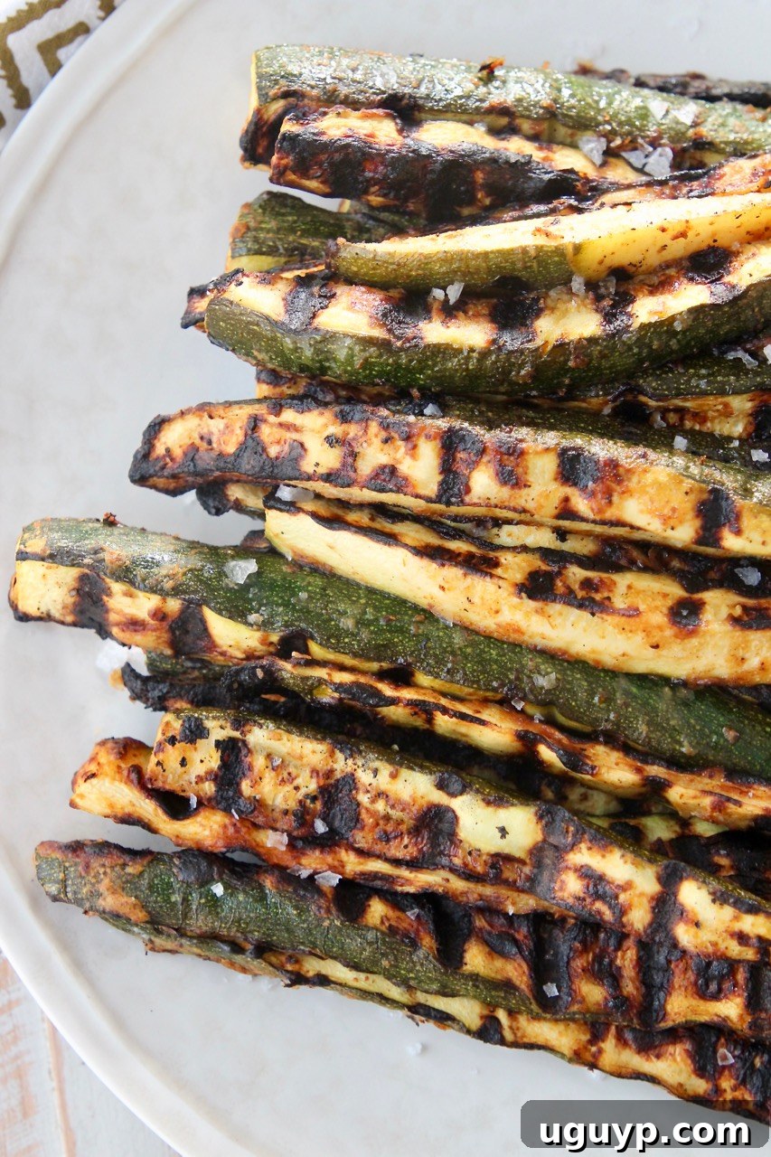 A close-up shot of easy, crispy grilled zucchini spears, perfectly charred and ready to be served.
