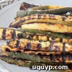 Grilled zucchini spears on plate