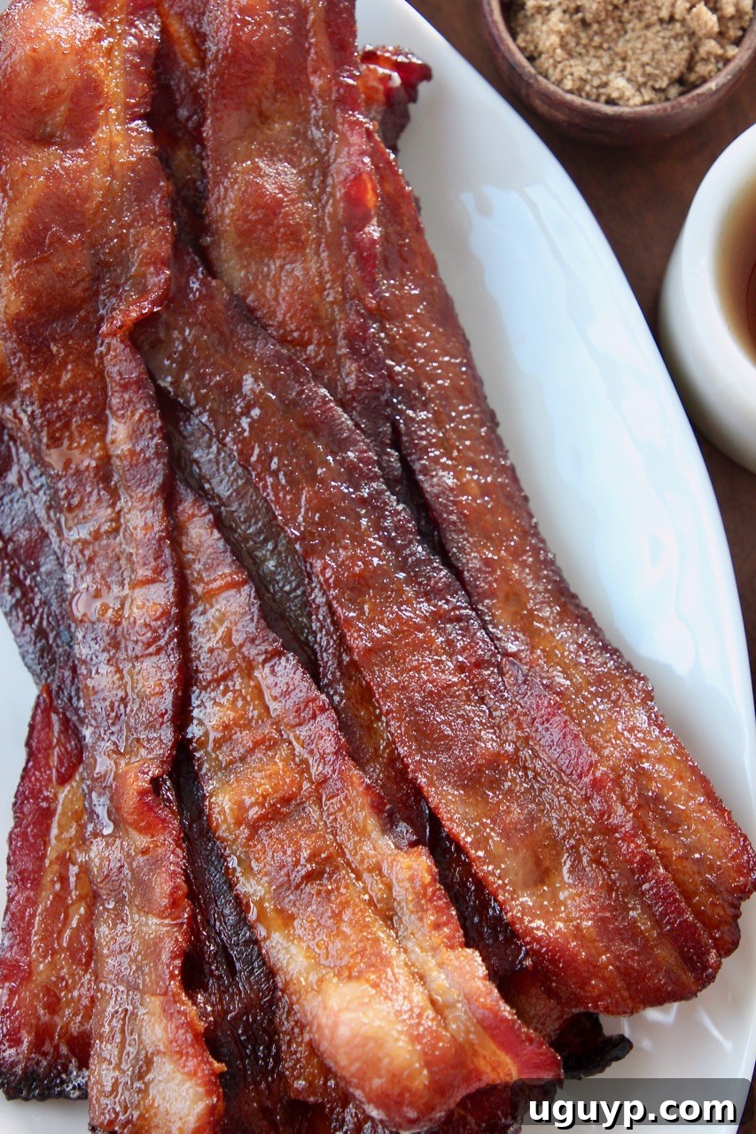 slices of cooked candied bacon on white plate