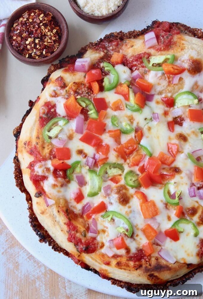 whole cooked pan pizza on marble serving tray with a golden, crispy crust