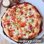 overhead image of cooked pan pizza on marble serving tray