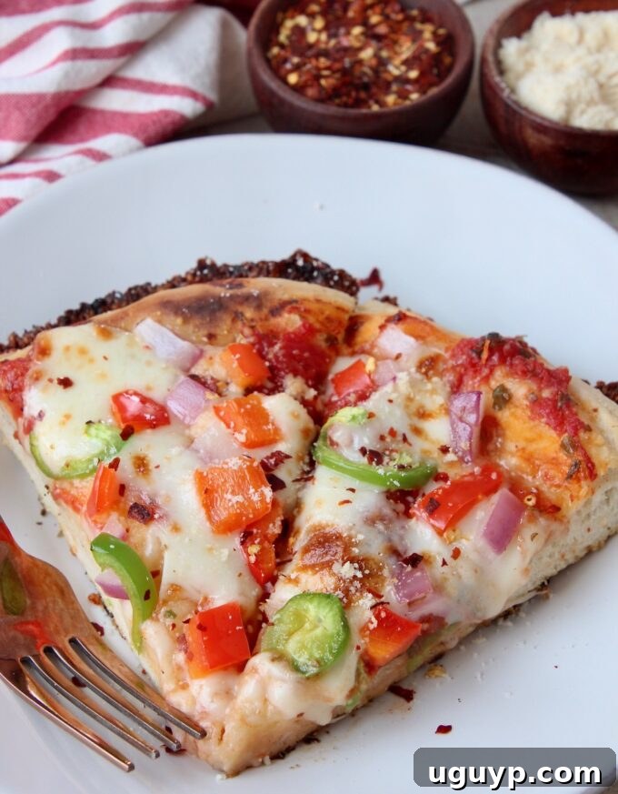 two slices of pan pizza with crispy edges on a white plate