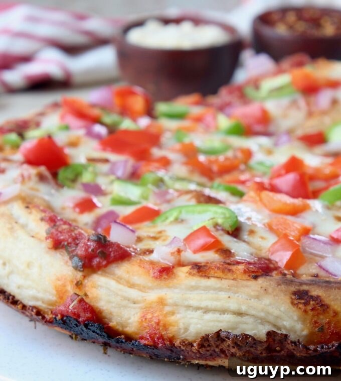 cooked pan pizza with crispy cheese crust and vibrant vegetable toppings