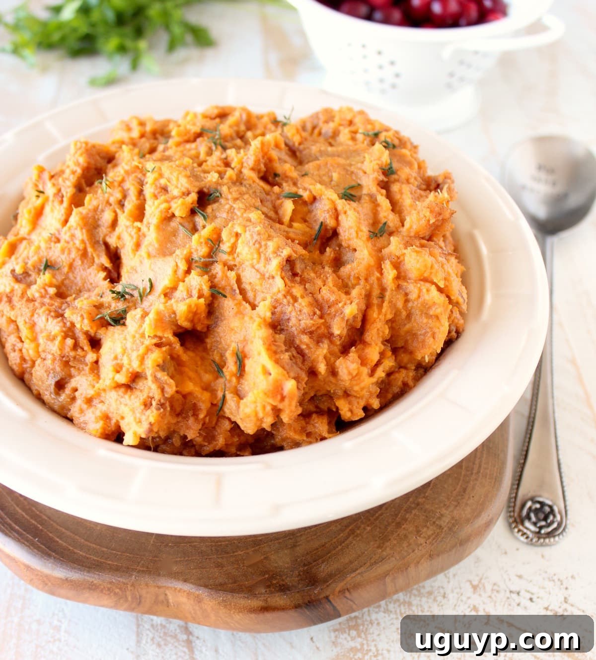 A top-down shot of a large bowl of Mashed Sweet Potatoes, garnished minimally.