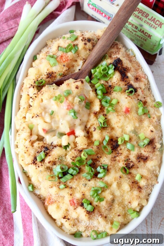 mac and cheese in oval serving dish with spoon