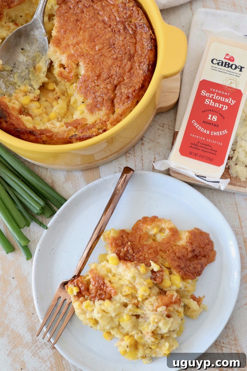 Individual serving of corn casserole on a plate alongside a larger portion in a yellow baking dish, showcasing its perfect texture.