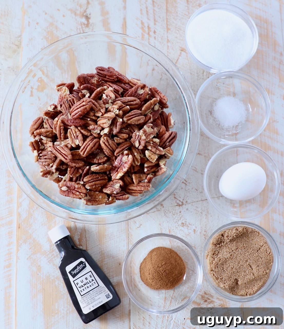 ingredients for candied pecans on white wood board