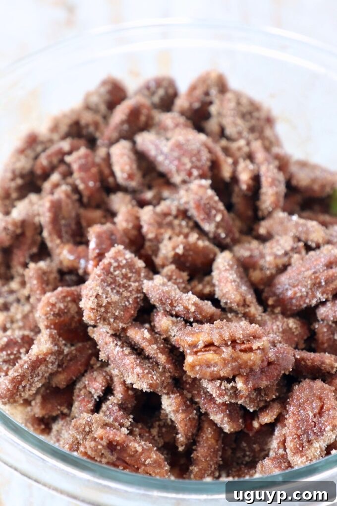 pecans coated in sugar in glass bowl