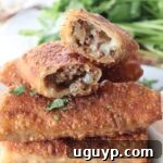 cheeseburger egg rolls stacked up on plate