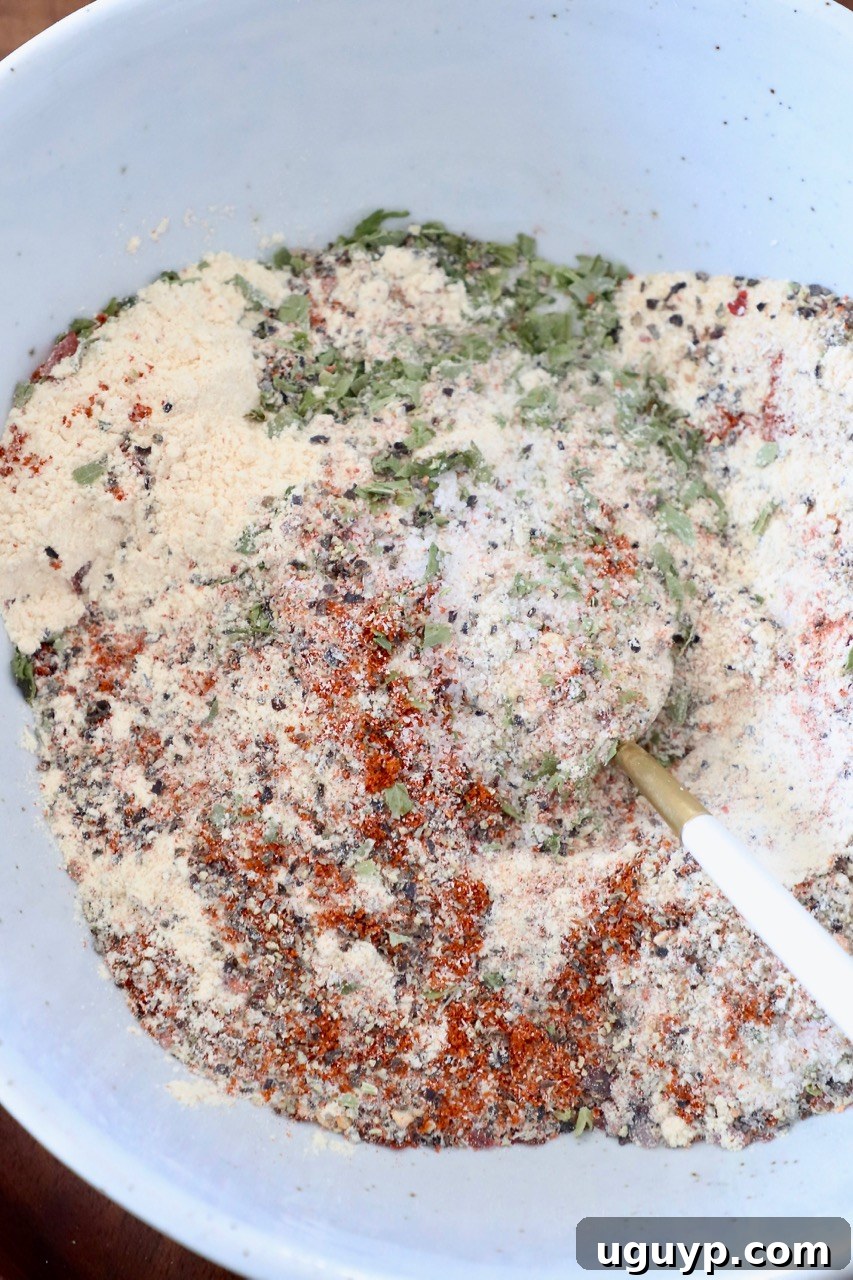 chicken seasoning mixed together in white bowl with spoon
