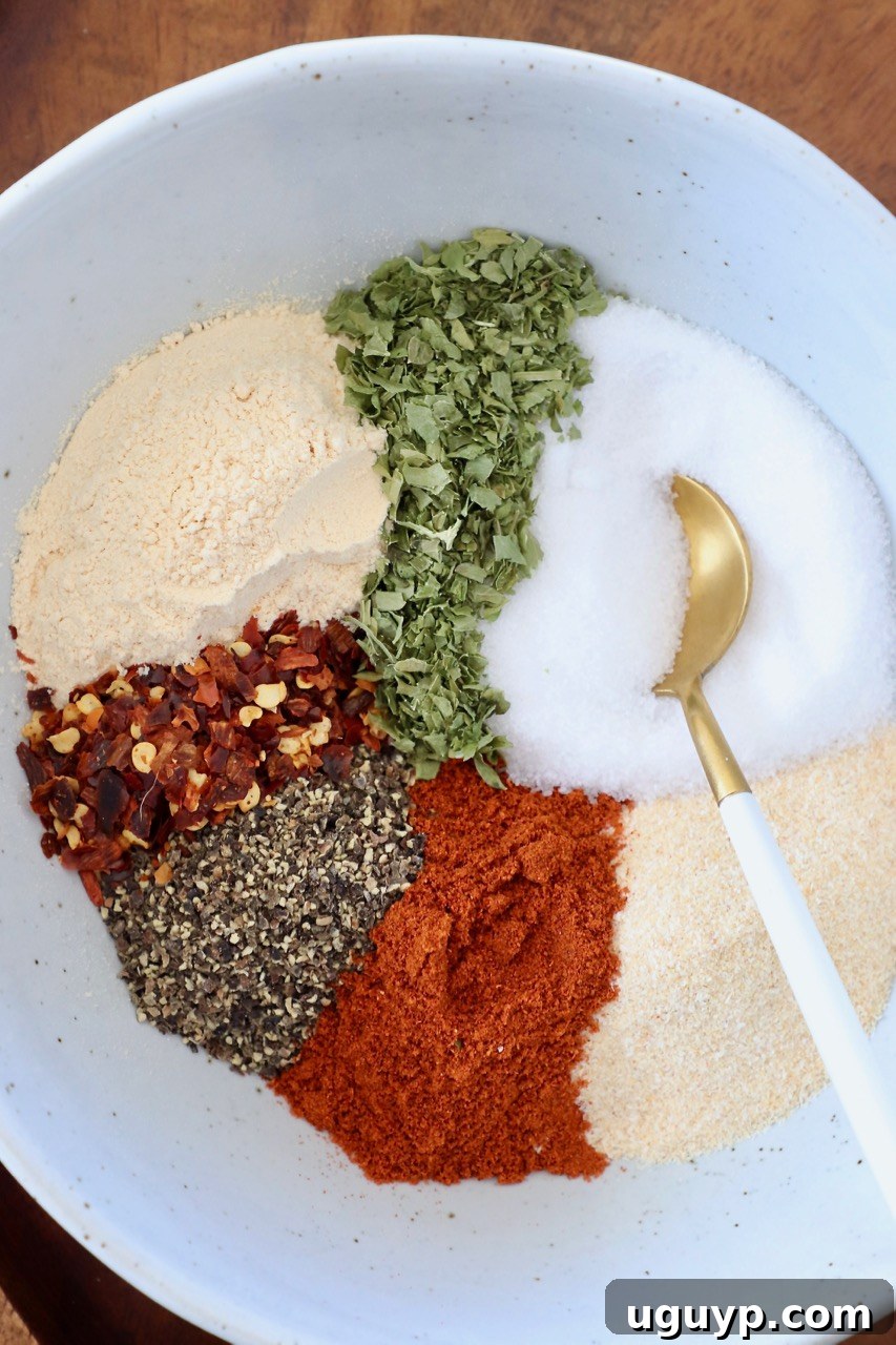 spices for chicken seasoning in bowl with gold spoon