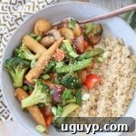 Stir fry vegetables in a bowl with rice and a fork, inviting a delicious meal.