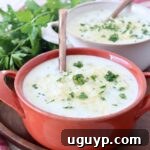 A cozy bowl of potato soup with a spoon, ready to be enjoyed as a comforting meal.