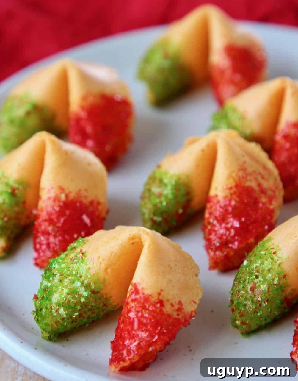 Festive Glitter Fortune Cookies with red and green edible glitter on a white plate, ready for a party.
