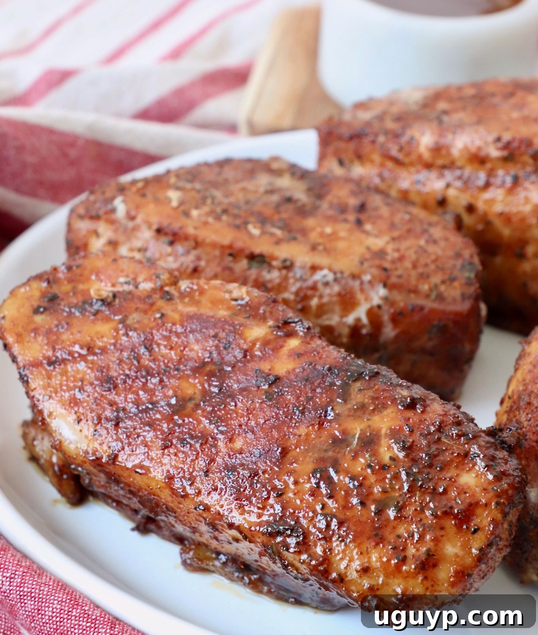 Smoked pork chops served on a plate, showcasing their juicy interior and perfectly seared exterior.