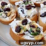 Platter of cranberry goat cheese crostini with honey drizzle.