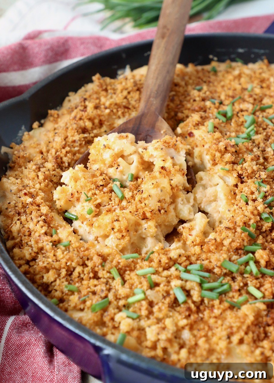 Smoked mac and cheese in a skillet, ready to be served, highlighting its creamy texture and crispy topping.