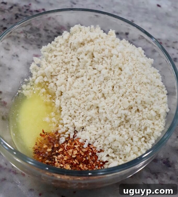 Panko breadcrumbs, melted butter, and steak seasoning mixed in a glass bowl for the crispy topping.