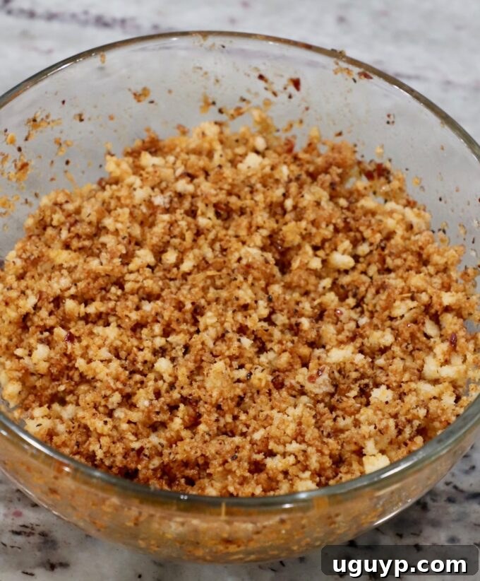 Seasoned panko breadcrumbs perfectly coated with butter, ready to be sprinkled over the mac and cheese.