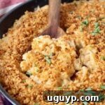 Smoked mac and cheese in skillet with serving spoon, ready to be dished out.