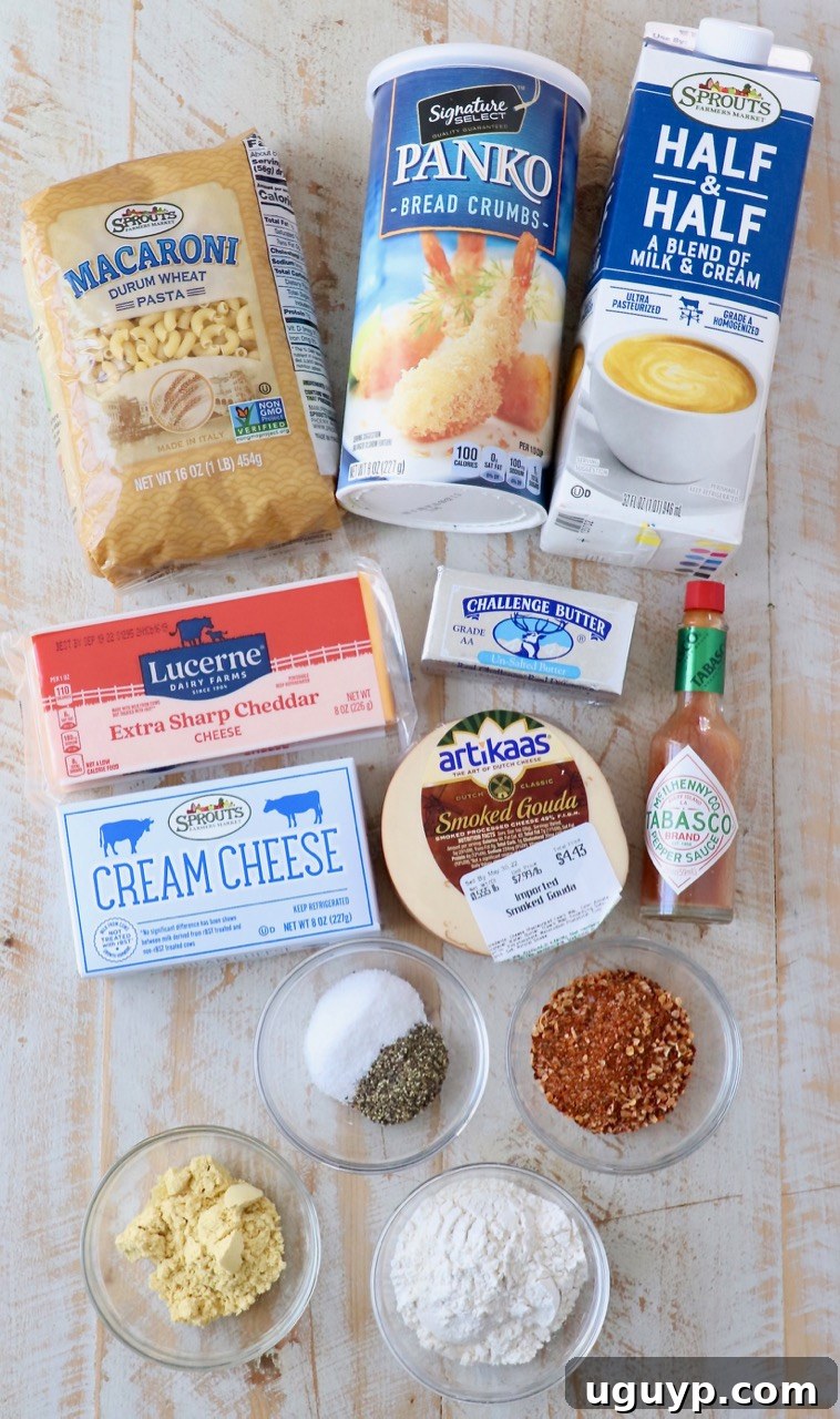 A selection of high-quality ingredients laid out, ready for making Smoked Mac and Cheese, including various cheeses, pasta, and seasonings.