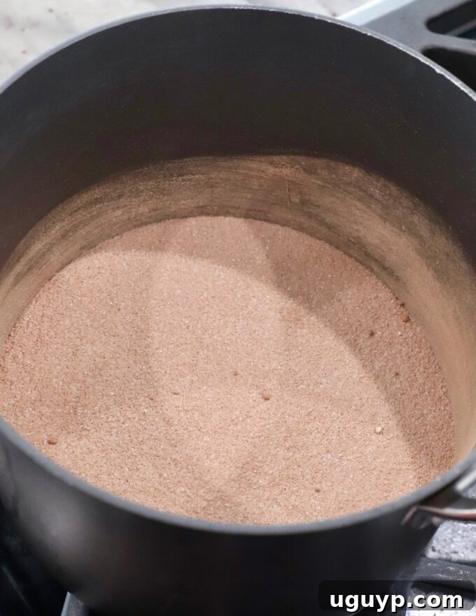 Granulated sugar, all-purpose flour, and unsweetened cocoa powder mixed together in a saucepan before adding wet ingredients.