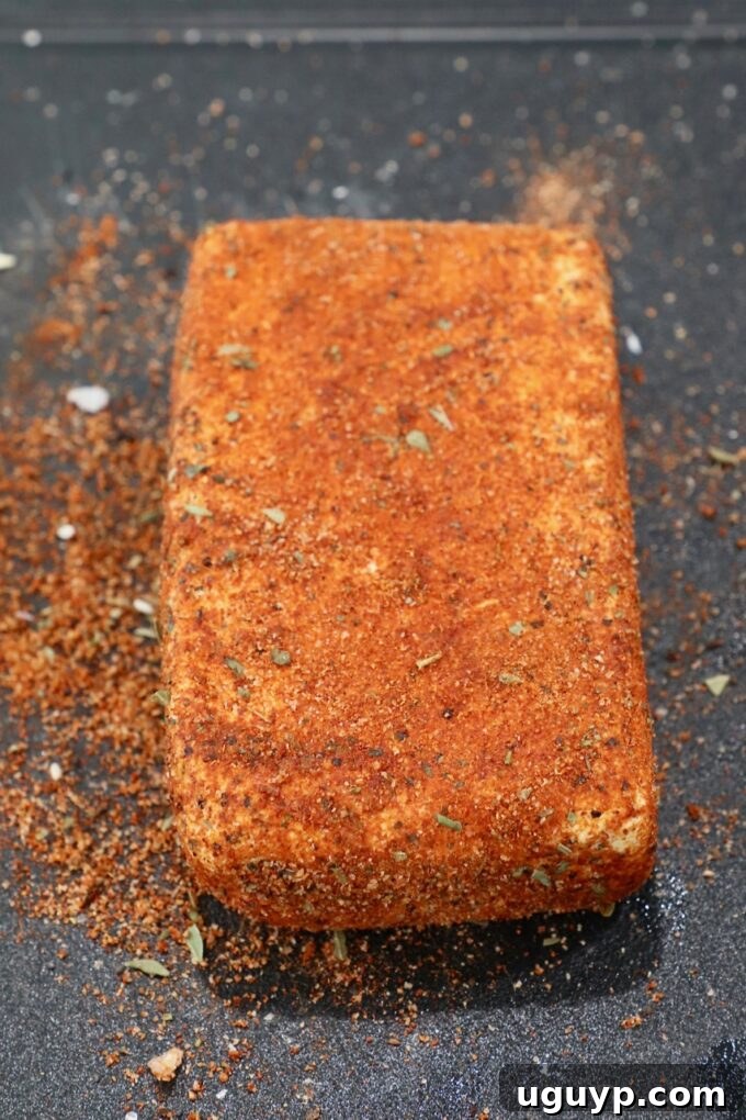 block of cream cheese coated in cajun seasoning