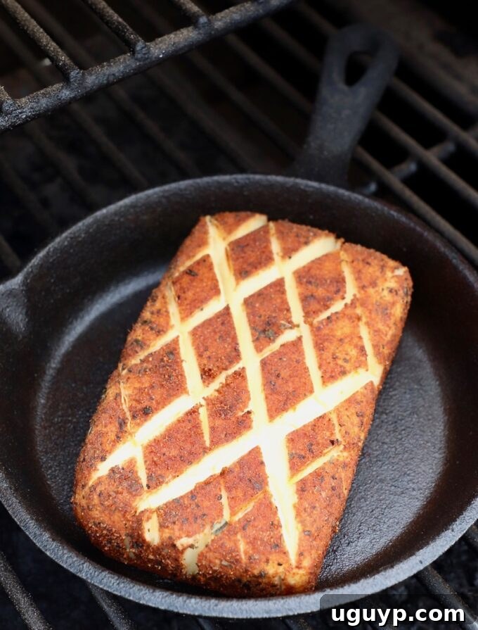 smoked cream cheese in cast iron skillet on smoker